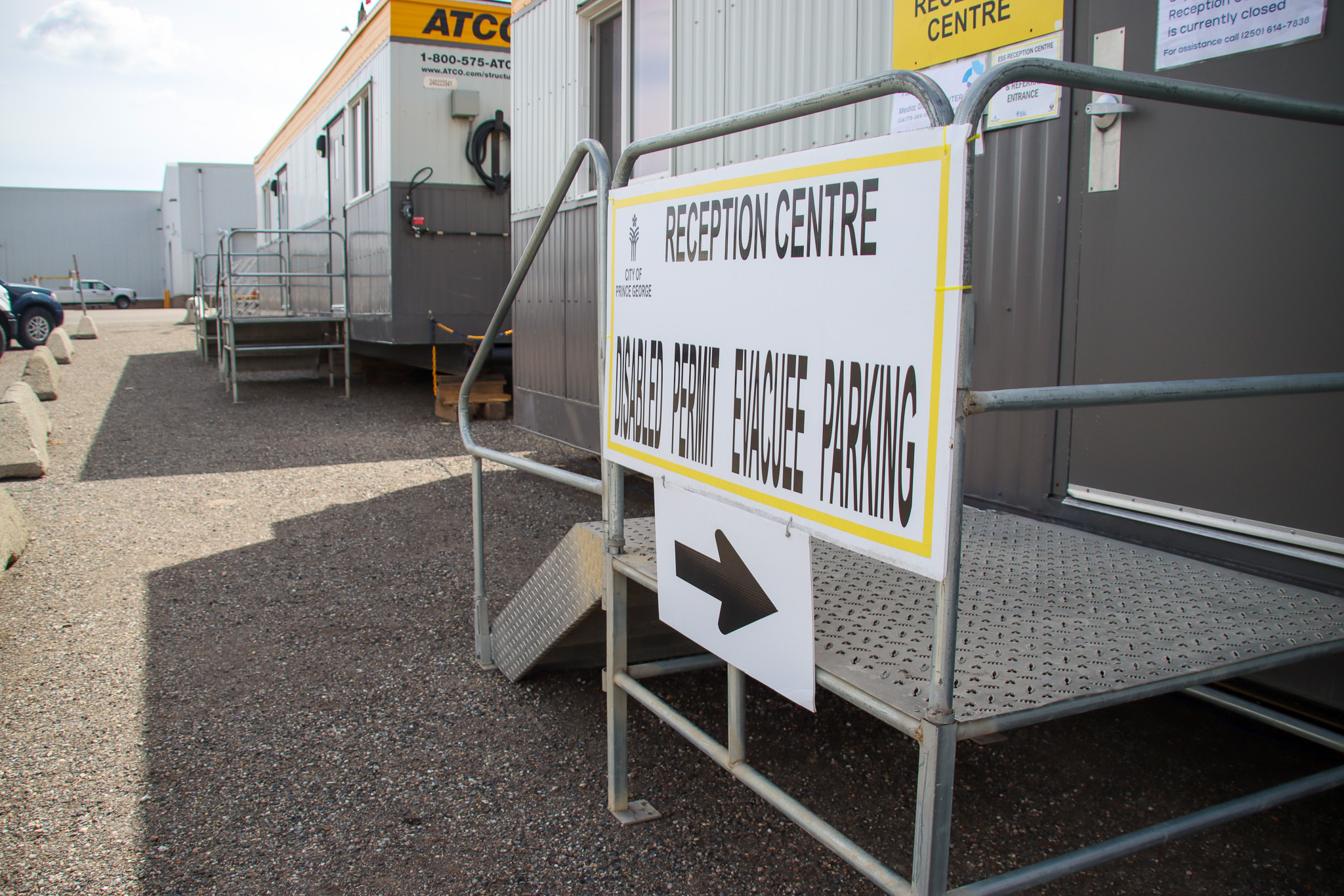 a photo showing a sign out the front of an ACTO trailer with another trailer in the background