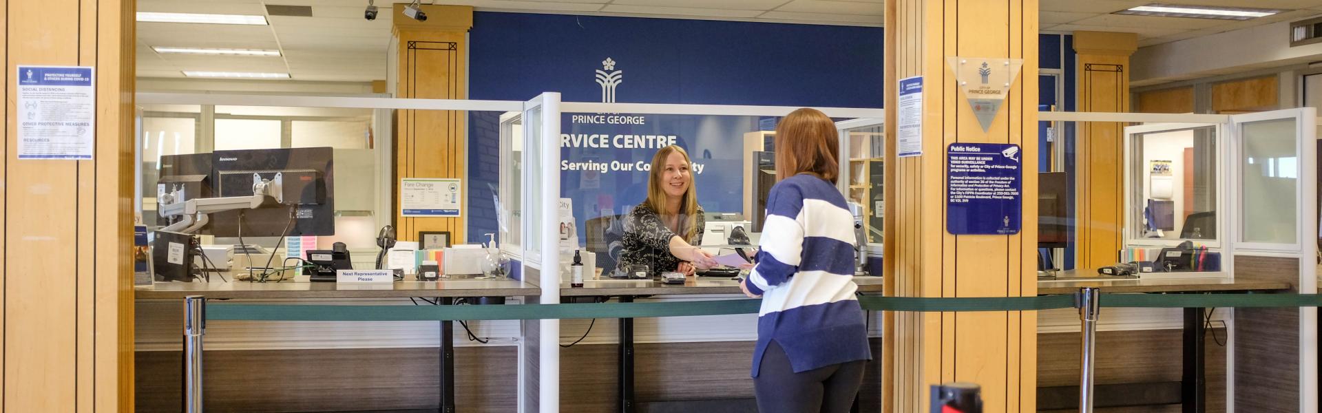 City hall service centre with customer being assisted by a member of the service centre staff