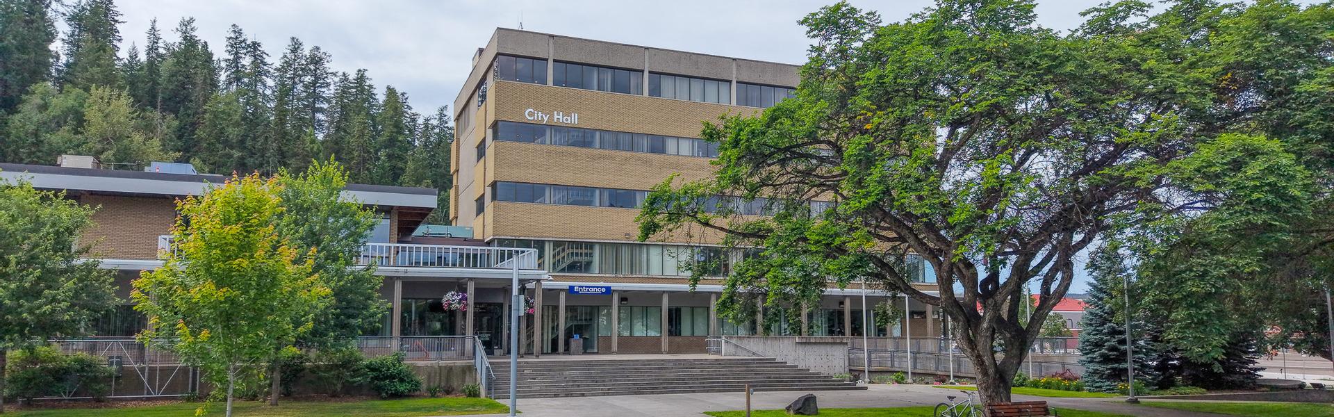 The exterior of Prince George City Hall, surrounded by trees