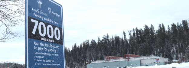 Pay parking sign in the new Civic Plaza parking lot. The sign reads: parking available here. Zone number 7000. 
