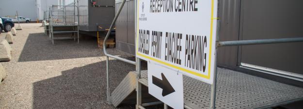 a photo showing a sign out the front of an ACTO trailer with another trailer in the background