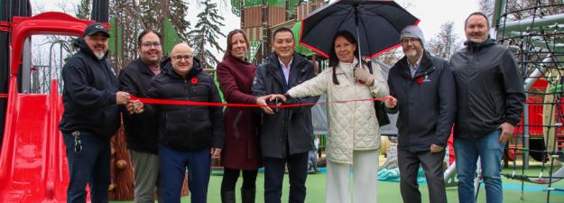 Representatives from the City of Prince George, Lheidli T'enneh, and Northern Development Initiatives Trust cutting the ribbon to open the new playground at Lheidli T'enneh Memorial Park