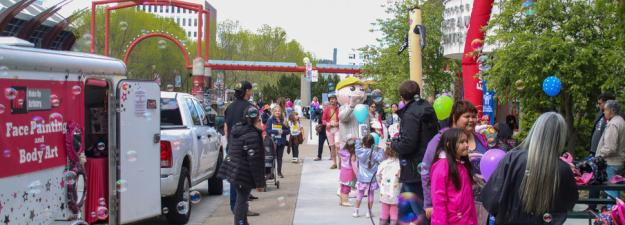 Crowd of people outside the Civic Centre holding balloons and meeting Mr. PG 