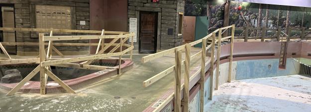 Safety barricades along the empty wave pool and hot tub at the Aquatic Centre