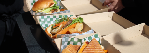 Three sandwiches in take out boxes at Foodie Fridays