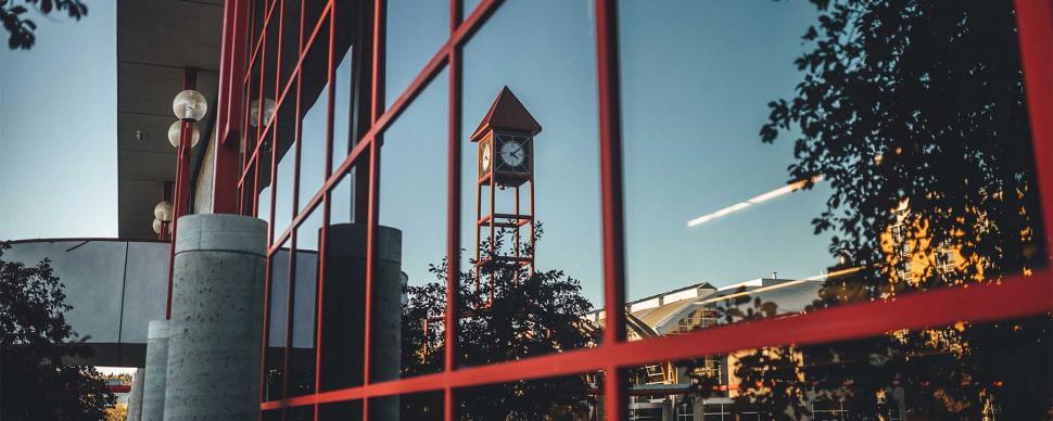A window reflection of the Prince George Conference and Civic Centre clock tower.