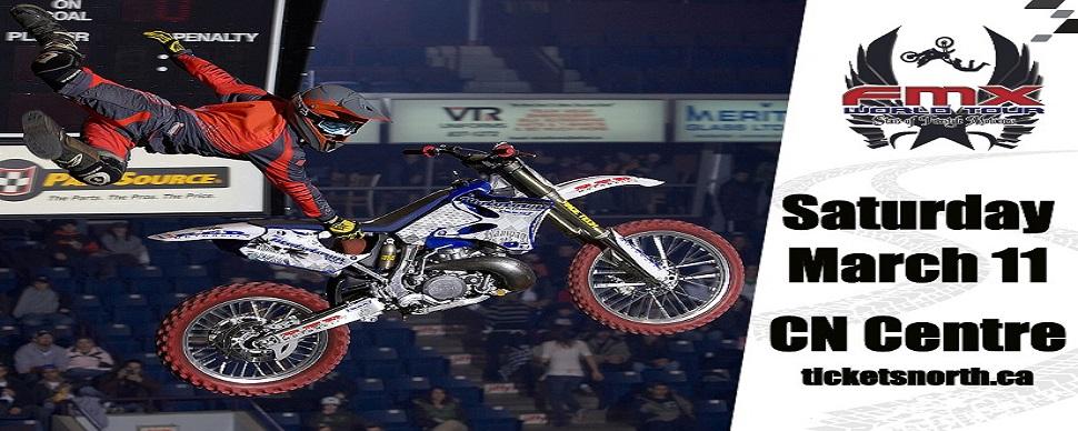 A rider on motocross bike is performing a jump for a crowd in an arena. FMX World Tour logo. Saturday March 11 CN Centre in bold black text.