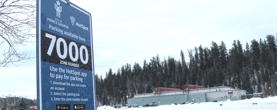 Pay parking sign in the new Civic Plaza parking lot. The sign reads: parking available here. Zone number 7000.