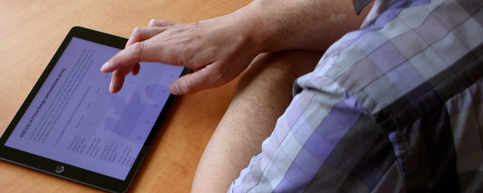 A person taking the communications and engagement survey on a tablet