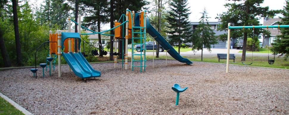 Playground equipment with a swing set and multiple slides