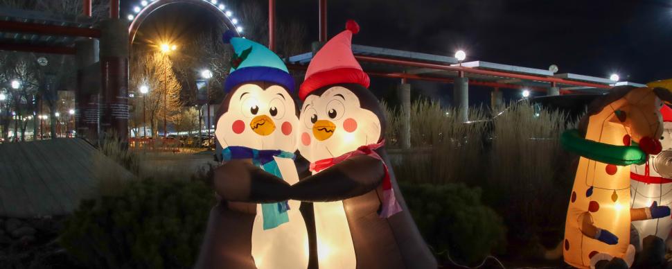 Two inflatable penguins hugging in front of Canada Games Plaza