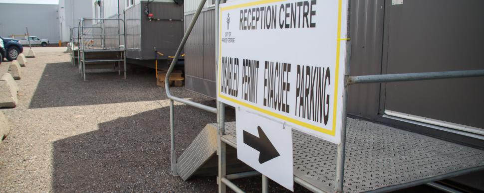 a photo showing a sign out the front of an ACTO trailer with another trailer in the background