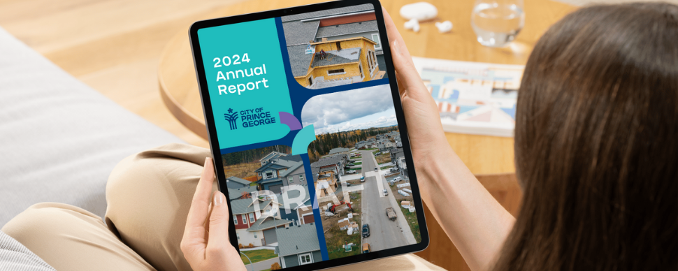 A woman reading the 2024 City of Prince George Annual Report Draft on an iPad 