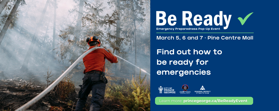 A wildfire fighter using a hose to spray a fire in the forest
