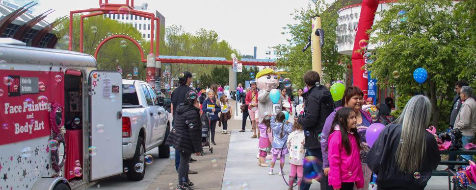 Crowd of people outside the Civic Centre holding balloons and meeting Mr. PG 