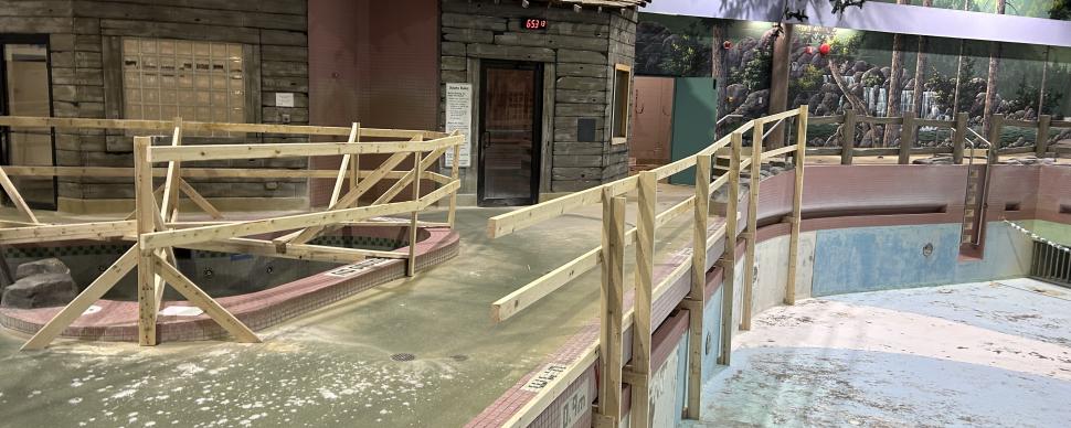 Safety barricades along the empty wave pool and hot tub at the Aquatic Centre