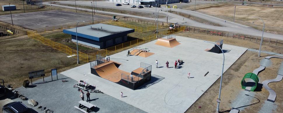 Aerial photo of Blackburn park, showing people using the skatepark with the washrooms and tennis courts in the background