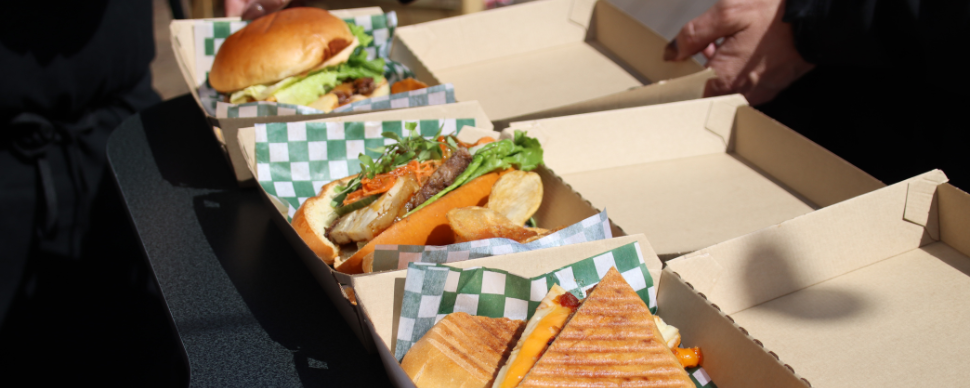 Three sandwiches in take out boxes at Foodie Fridays