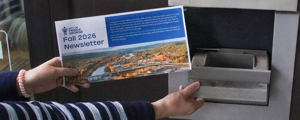 A person dropping the City's fall 2026 mailed newsletter into a mailbox