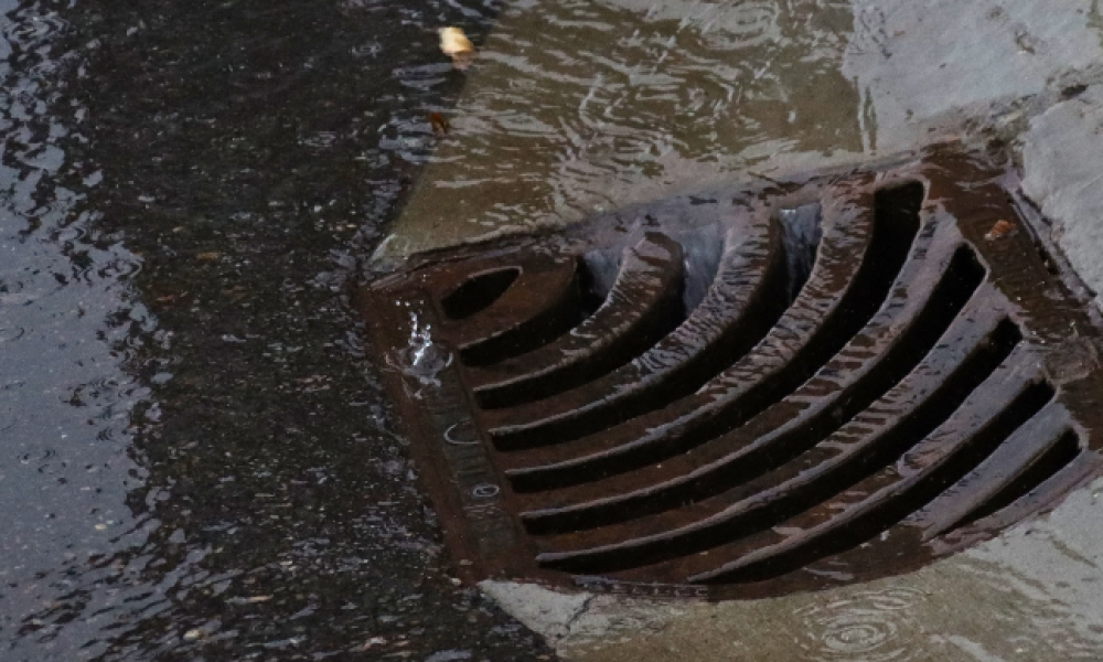 A storm drain on a rainy street